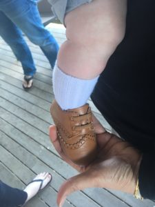 Image of a baby's foot in a shoe.